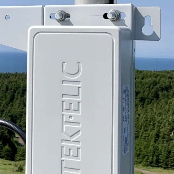 A pole-mounted outdoor gateway in a sealed enclosure on its mounting
      bracket